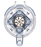 Top-down view of an empty, transparent Vitamix blender jar featuring the Aer Blend Disc Assembly with four angled blades at the base and a central metal component; handle is visible at the bottom, and the jar has a slightly blue tint.