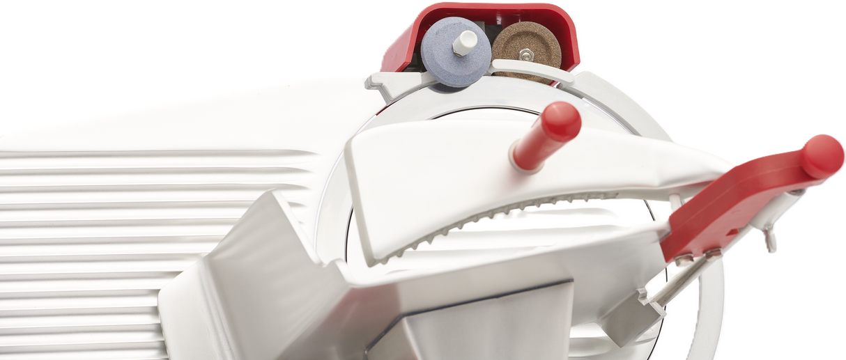 Close-up of a white Berkel B10-SLC gravity feed slicer with two prominent red handles. The angled blade, adjustment dials, and textured surface showcase its modern and functional design, highlighting the slicers mechanical details.