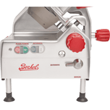 Close-up side view of a silver Berkel automatic slicer. Visible are control buttons labeled Blade Power and Automatic, a large red adjustment knob, manual/automatic switch, the red Berkel logo, and black rubber-tipped feet at the bottom.