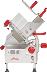 A commercial gravity feed slicer with a tilted stainless steel body, red handle, and control knobs. It features labeled buttons, a sliding tray for holding food, an exposed 12 carbon steel knife blade, and the Berkel brand on the front panel.