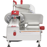 A commercial gravity feed slicer with a silver body, red knobs, and a “Berkel” logo on the front. Featuring a 12 carbon steel knife and round blade, this machine is designed for slicing deli meats and includes visible safety warning labels.