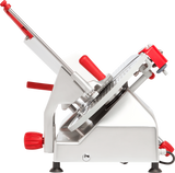 A commercial manual gravity feed slicer with a shiny silver body and bright red handles is shown side-on. It features a circular serrated carbon steel knife and an adjustable angled tray for smooth sliding and slicing of food items.