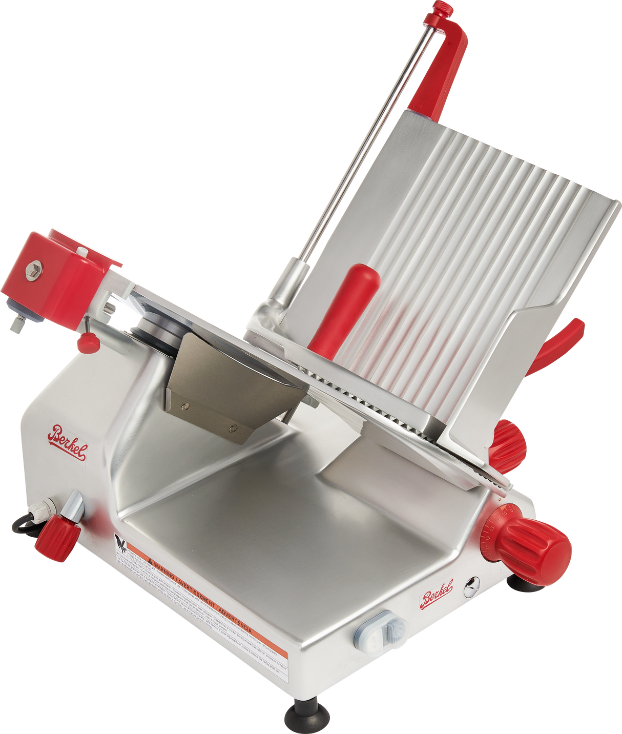 A commercial-grade manual gravity feed slicer with a silver metal body, red knobs and handles, tilted grooved platform for holding food, carbon steel knife, large blade guard, and sturdy black feet for stability is shown on a white background.