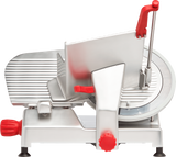A commercial manual gravity feed slicer with a metallic body, carbon steel knife, adjustable slicing thickness knobs, and red handles. The slicer features a sliding tray for food placement and safety guards, all set against a white background.