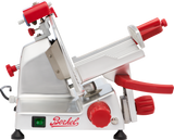 A stainless steel Berkel gravity feed slicer with red knobs and handles, a tilted adjustable platform, and a sharp circular blade. The machine has an on/off switch and the Berkel logo in red. Its overall design is modern and industrial.