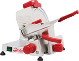 A silver Berkel slicer with red accents—including knobs, handle, and logo—features a circular blade, adjustable thickness dial, safety guard, and green on/off switch. This gravity feed slicer is positioned at an angle for easy use.