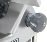 Close-up of a gray metal Heavy Duty Marine Meat Slicer featuring a large round adjustment knob with a ridged grip. The knob is numbered from 0 to 15 for thickness settings, and the surrounding area is metallic and slightly reflective.