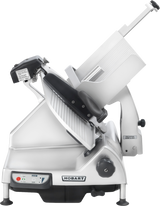 A Heavy Duty Meat Slicer with a silver metallic body and angled blade. Featuring a 13 CleanCut knife, safety guards, sliding tray, control panel with buttons, and a thickness handle. The machine is labeled Hobart on its side.