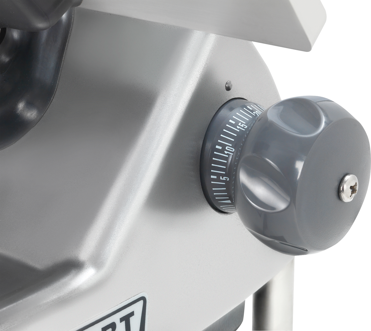 Close-up of a gray rotary dial with white numbers and a ridged grip on a Heavy Duty Meat Slicer. The dial, set between 5 and 10, is attached to smooth, reflective metal; part of a label is partially visible below.
