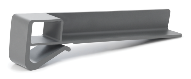 A gray, L-shaped plastic object with a hollow square section on one end and a curved hook extending from the base. This minimalist product fence is a functional, modern accessory—possibly a clip or holder for organizing items.