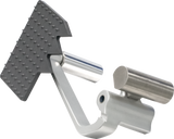 A close-up of a metal adjustable rowing foot stretcher with a textured black T-shaped footplate, similar in finish to a Heavy Duty Meat Slicer, and cylindrical silver heel support on a silver mounting bracket. The background is plain and light gray.