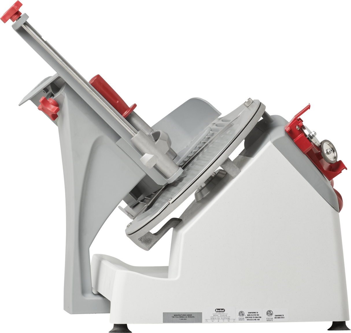 A side view of the Berkel X13-PLUS manual food slicer with a tilted silver blade, gray body, and red safety features. The slicer includes adjustment knobs, a handle, and serrated platform for holding food, set against a plain white background.
