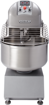 A commercial Hobart Spiral Mixer with a large stainless steel mixing bowl, spiral dough hook, protective wire guard, and user-friendly control panel. This industrial-sized, metallic gray mixer boasts an impressive 180-pound capacity and sturdy base for stability.