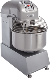A commercial stainless steel Hobart Spiral Mixer with a large 180-pound capacity bowl, spiral dough hook, control panel with buttons and dials, and protective wire guard—designed for heavy-duty food prep on a sturdy base with adjustable feet.