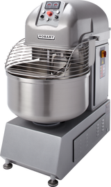 A large Hobart Spiral Mixer with a 220-pound capacity, featuring a stainless steel bowl, spiral dough hook, protective wire guard, and a control panel on top. The metallic gray mixer is mounted on a sturdy base with visible warning labels.