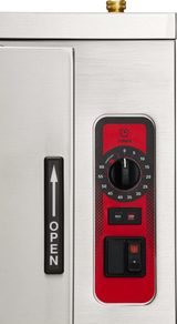 Close-up of a countertop electric steamer with a stainless steel finish, featuring a vertical black handle labeled OPEN, red timer dial marked 0–60 minutes, status lights for READY and COOK, and two black switches with one orange indicator.