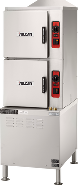 A commercial Vulcan stainless steel double-deck convection steamer with an electric steam generator features two front-facing doors, each with a black handle and red and black control panels with dials and indicator lights, standing on four sturdy legs.