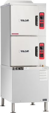 A commercial stainless steel Vulcan convection steamer with a gas steam generator features two separate front-loading compartments, each with a black handle and red-accented control panel. This commercial kitchen equipment stands on four sturdy metal legs.