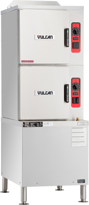 A commercial stainless steel Vulcan convection steamer with a gas steam generator features two separate front-loading compartments, each with a black handle and red-accented control panel. This commercial kitchen equipment stands on four sturdy metal legs.