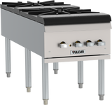 The Vulcan VSP200F Stock Pot Range features a stainless steel design with four black gas burners, each controlled by a silver knob. Supported by sturdy metal legs, the stove proudly displays the "Vulcan" brand on its front panel.