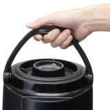 A close-up of a hand grasping the handle of a black insulated thermos jug. The jug has a circular lid with a visible gray gasket, and the handle arches over the top, attached on both sides. The background is plain white.