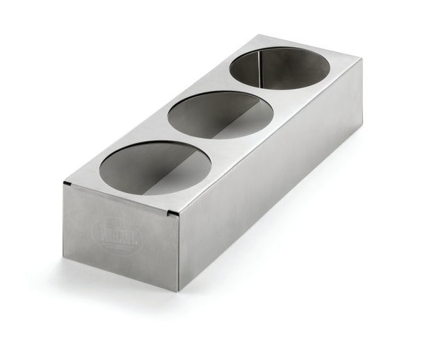 A rectangular stainless steel squeeze bottle holder with three circular cutouts on the top surface, set against a white background. The brushed finish and engraved logo on the front left side give this expandable counter-top accessory a sleek look.