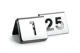 Two TableCraft stainless steel table number signs are displayed on a white background. This number tent set features signs for 1 and 25, each tent-shaped with large, bold cut-out numbers.
