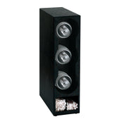 A vertical black coffee pod holder, also usable as a straw organizer, features three round pods stacked horizontally in individual slots and an open compartment at the bottom with shredded paper. The background is plain white.