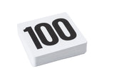 A stack of white plastic TableCraft Number Card Sign Set cards with the number 100 printed in large, bold black font on the top card, photographed against a plain white background.