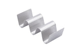 The Taco Taxi Server is a stainless steel holder with a wavy zigzag design, featuring three curved slots that holds 2-3 tacos upright. A plain white background highlights its metallic finish and sleek, modern look.