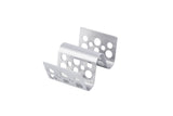 A silver, stainless steel Taco Taxi Server bracket with multiple round holes and an S-shaped, wave-like center. It has flat ends and holds 1-2 tacos securely. The background is plain white.
