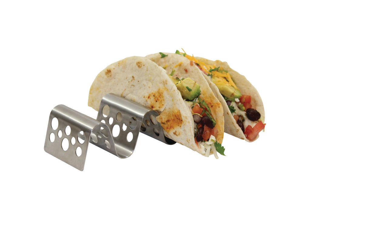 Two flour tortillas filled with beans, lettuce, tomato, cheese, and cilantro are placed upright in a Taco Taxi Server stainless steel taco holder with circular holes, against a plain white background. The holder is sturdy and dishwasher safe.