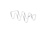A metal object made of a single, shiny silver rod bent into wavy peaks and valleys stands on a white background. This minimalist, abstract sculpture is actually a stainless steel taco holder—dishwasher safe for easy cleaning—perfect as a Taco Taxi Server.