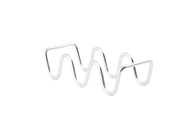 A metal object made of a single, shiny silver rod bent into wavy peaks and valleys stands on a white background. This minimalist, abstract sculpture is actually a stainless steel taco holder—dishwasher safe for easy cleaning—perfect as a Taco Taxi Server.