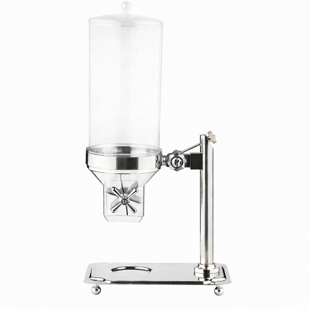 The TableCraft Cereal Dispenser features a clear cylindrical container, sleek stainless steel design, and a convenient paddle handle for easy dispensing. Its sturdy rectangular base with circular cutout and round feet adds a modern touch.
