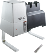 A modern, industrial Hobart 403 Meat Tenderizer with sturdy legs, a labeled control switch, safety warning, and black plastic top. A metal comb accessory rests nearby. This countertop model is designed for efficient food prep in any kitchen.