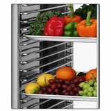 A metal rack features a Turbo Air PRO-77 tray slide kit holding two shelves of fresh produce: the top shelf displays green kale and colorful bell peppers, while the lower shelf has grapes, oranges, limes, and lemons against a plain white background.