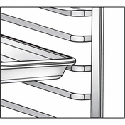 A metal baking sheet rests on angled racks of a Turbo Air PRO-77 bakery rack. The image is close up, showing the tray partially pulled out from the Tray Slide Kit, with empty horizontal slots above and below, against a white background.