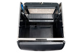 A top-down view of an empty, open black plastic compartment with a removable white filter and grid panel at the back, possibly from a cube style ice maker or appliance’s dustbin, against a white background.