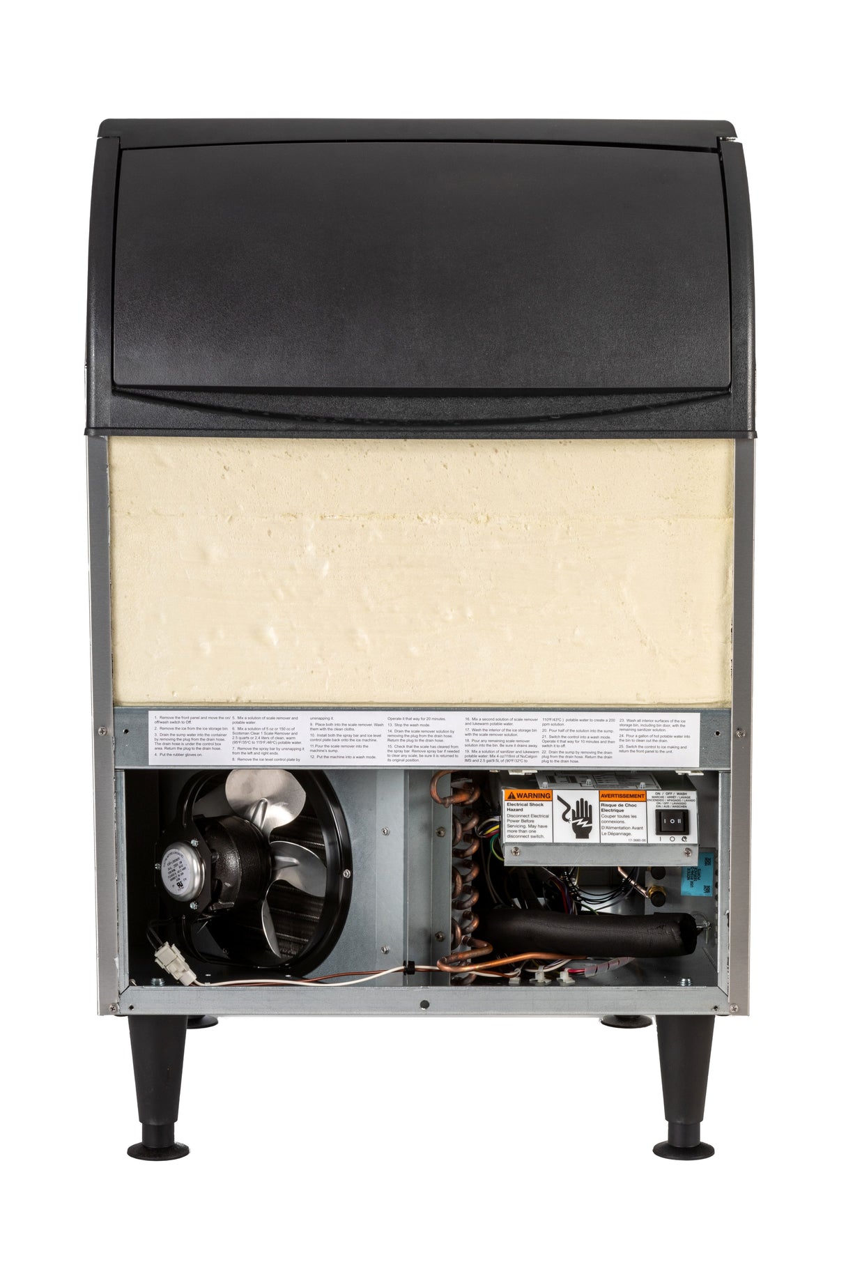 An undercounter ice maker with its bottom panel open reveals internal mechanical components like a fan, wiring, and control boards. The upper section is insulated, while the exterior is silver with black legs and a black lid, ideal for ice bin storage.
