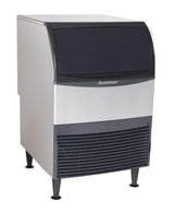A commercial undercounter ice maker with a black top door, silver body, and black vented panel at the bottom. The machine stands on four legs and features the brand name “Scotsman” on the front.