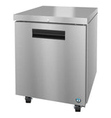 A stainless steel, single-door Hoshizaki Steelheart commercial undercounter freezer with a flat top, black handle, locking caster wheels, and a small certification sticker on the bottom right corner. The appliance has a sleek, modern design.