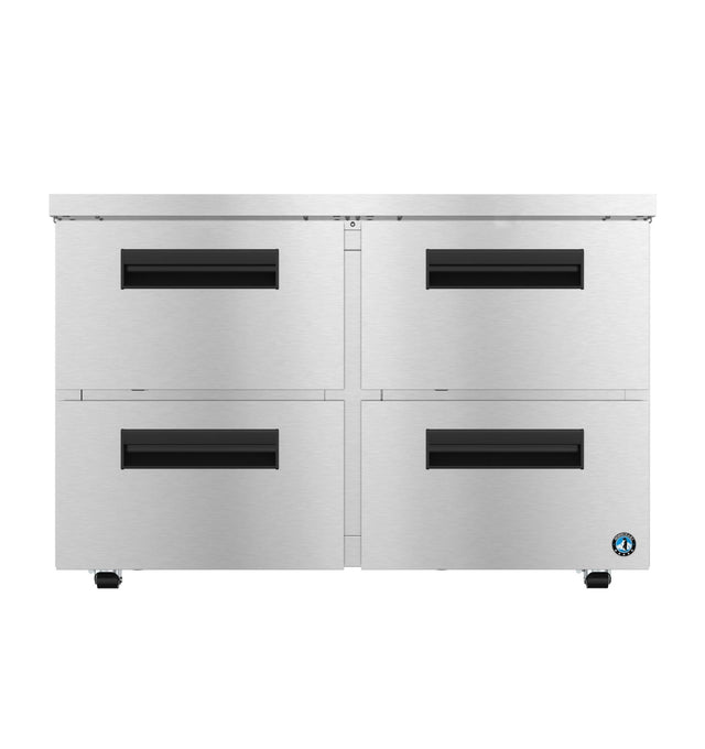 A commercial Steelheart Series undercounter freezer with four front-facing stainless steel drawers, each featuring black recessed handles. The brushed metal unit rests on small wheels, with a blue circular logo on the bottom right corner.