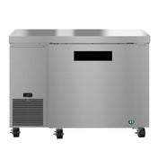 A commercial stainless steel freezer or prep table on wheels, with a solid door, digital control panel on the lower left, and a smooth flat top surface. This undercounter freezer stands out against a plain white background.