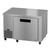 A Hoshizaki stainless steel commercial undercounter freezer with a single solid door, digital temperature display on the lower left, ventilation panel, four caster wheels, and a horizontal handle slot is shown against a white background.