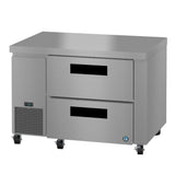 A durable Hoshizaki undercounter refrigerator with two large pull-out drawers, digital temperature display, ventilation grilles, four caster wheels for easy mobility, and a flat stainless steel surface ideal as a prep table.