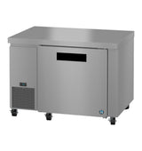 A commercial stainless steel undercounter refrigerator with a flat top surface, one solid door featuring a black handle slot, ENERGY STAR certification, digital temperature display, left-side ventilation grilles, and four caster wheels.