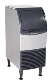 A silver and gray Scotsman Undercounter Ice Maker stands on four black legs. The front features a curved black lid above a vented panel. This modern appliance produces chewable ice and has a functional design, isolated on a white background.