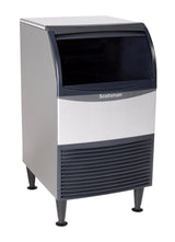 A freestanding Scotsman ADA compliant undercounter ice maker with a silver body and black accents, featuring a front-opening door and vented panel at the bottom. The machine stands on four black legs and has a modern, boxy design.