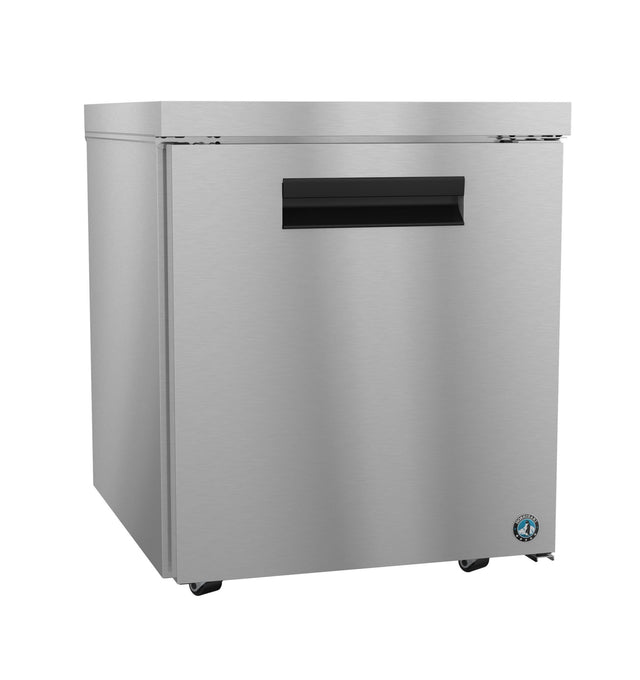 A commercial undercounter refrigerator with a single door, black horizontal handle, and small wheels. The smooth, reflective stainless steel surface features a blue circular logo on the lower right corner for a sleek professional touch.